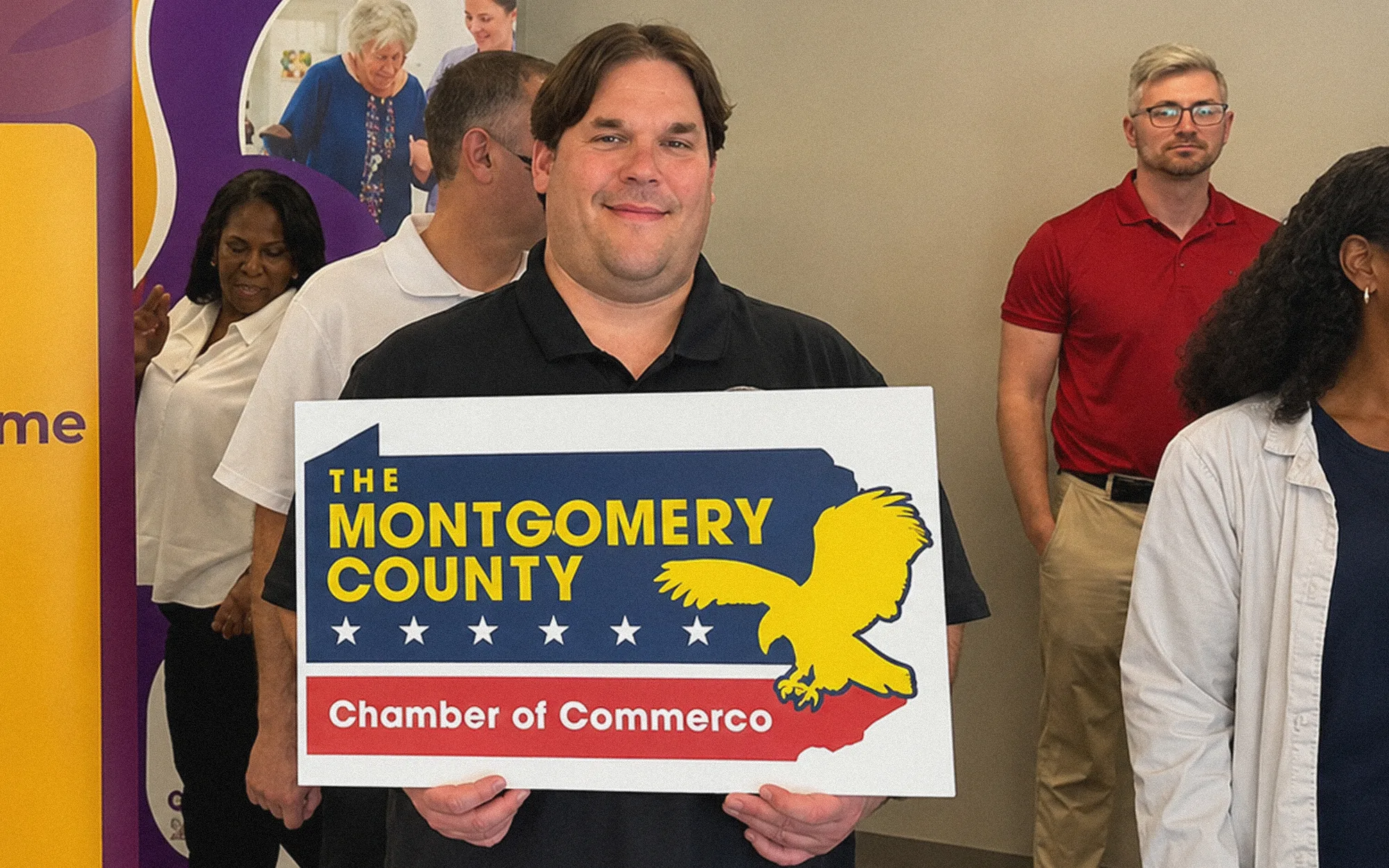 Guest holding a Montgomery County Chamber of Commerce sign