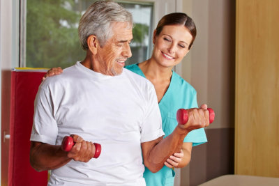 elder man and his caregiver assisting him