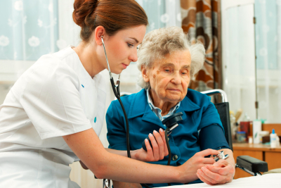 caregiver checking elderly woman