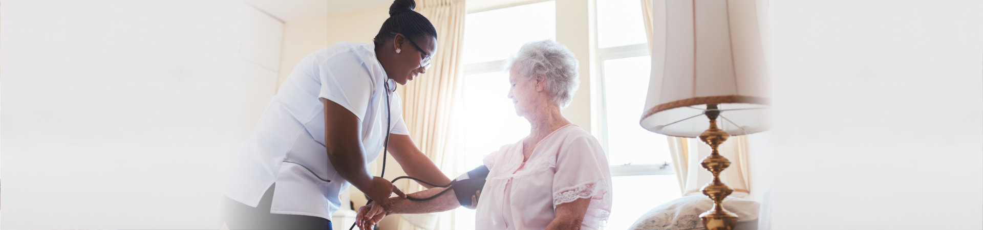 nurse doing blood pressure measurement of a senior woman patient