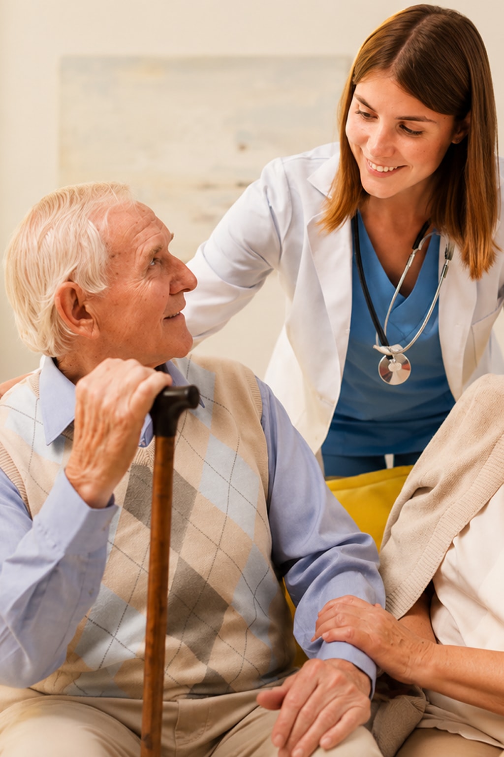 Home health care nurse comforting senior man with cane