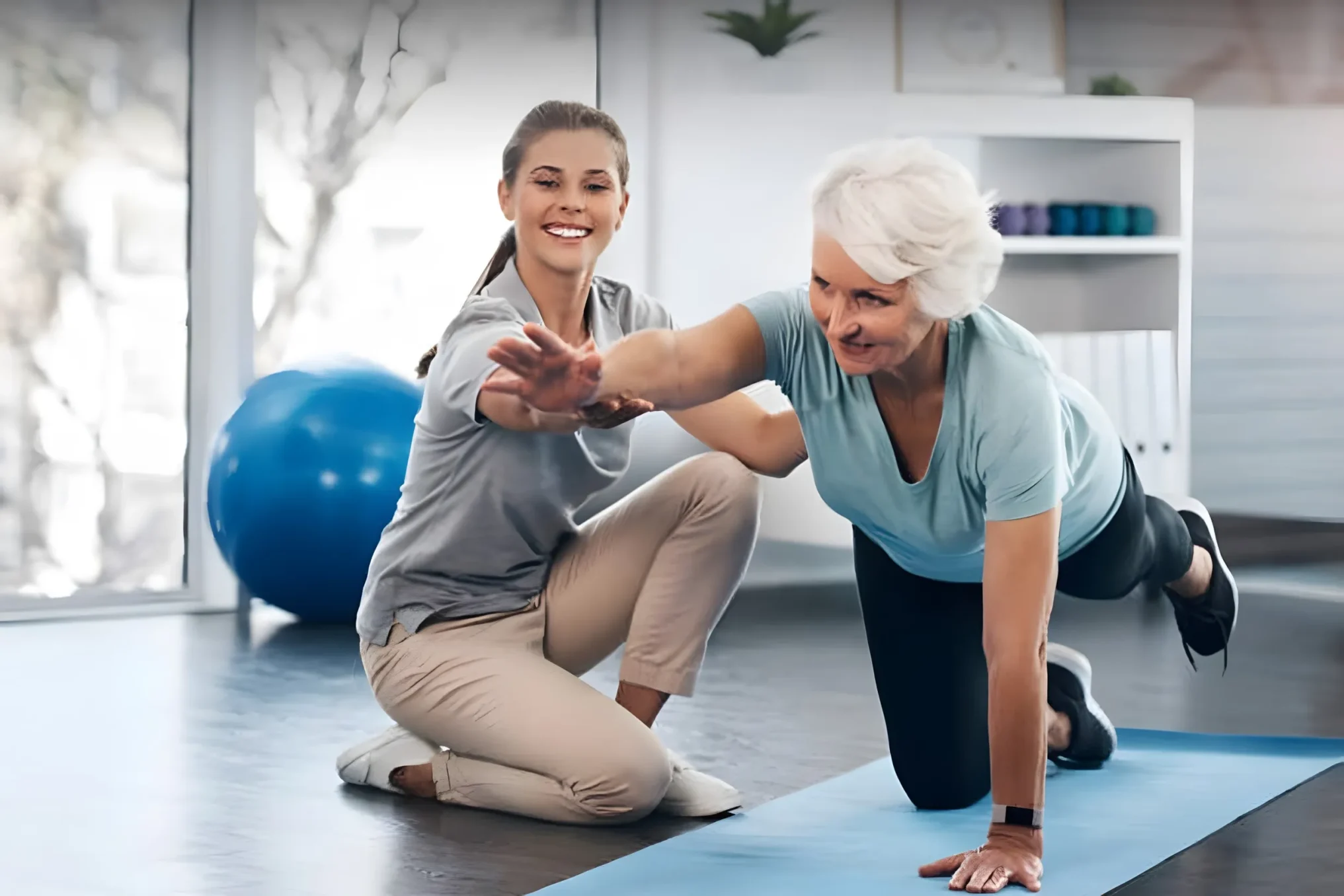 Home care assistant helping elderly client with daily exercise routine
