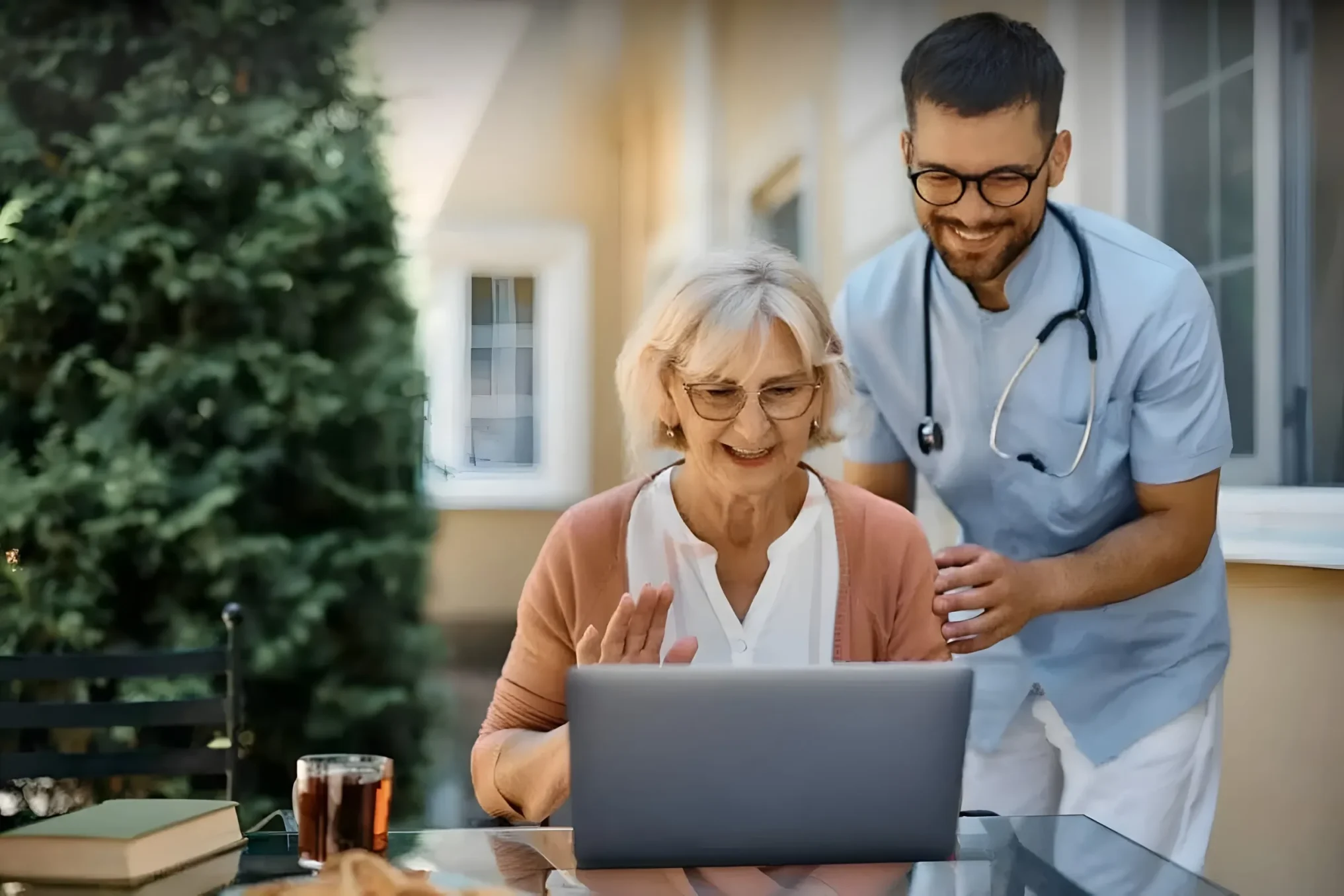 Caregiver assisting senior with video call